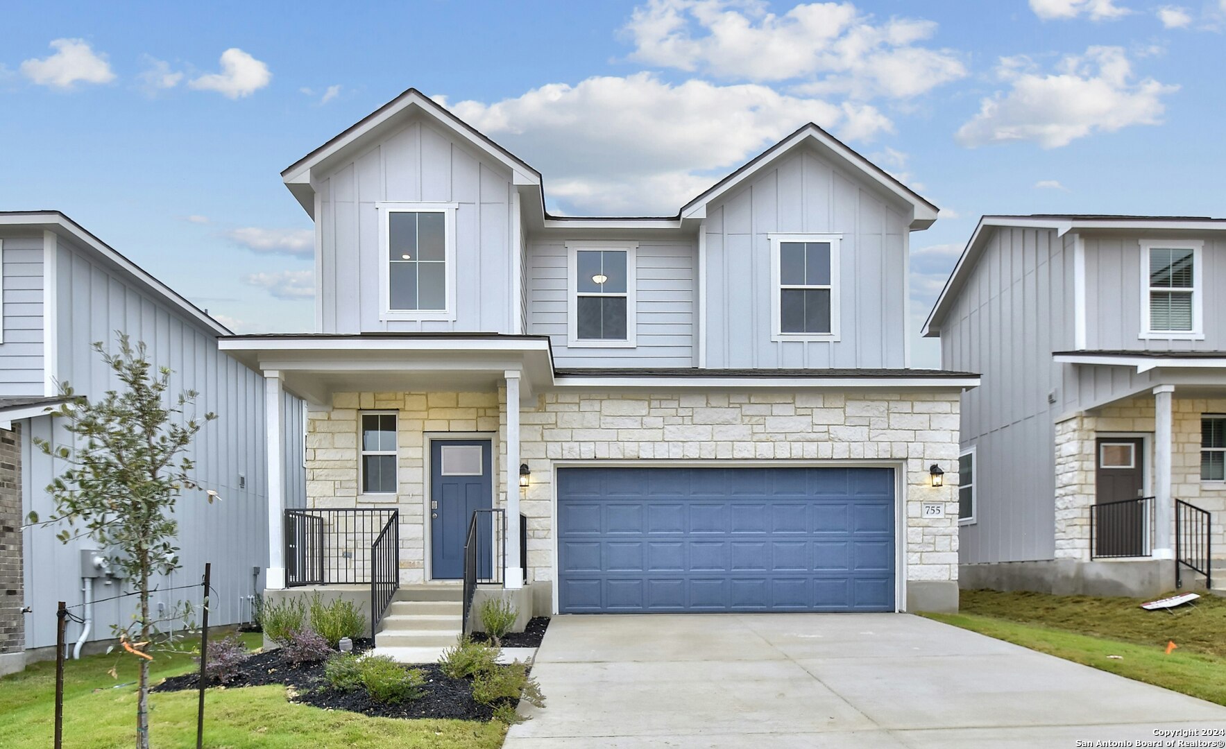 a front view of a house with a yard and garage