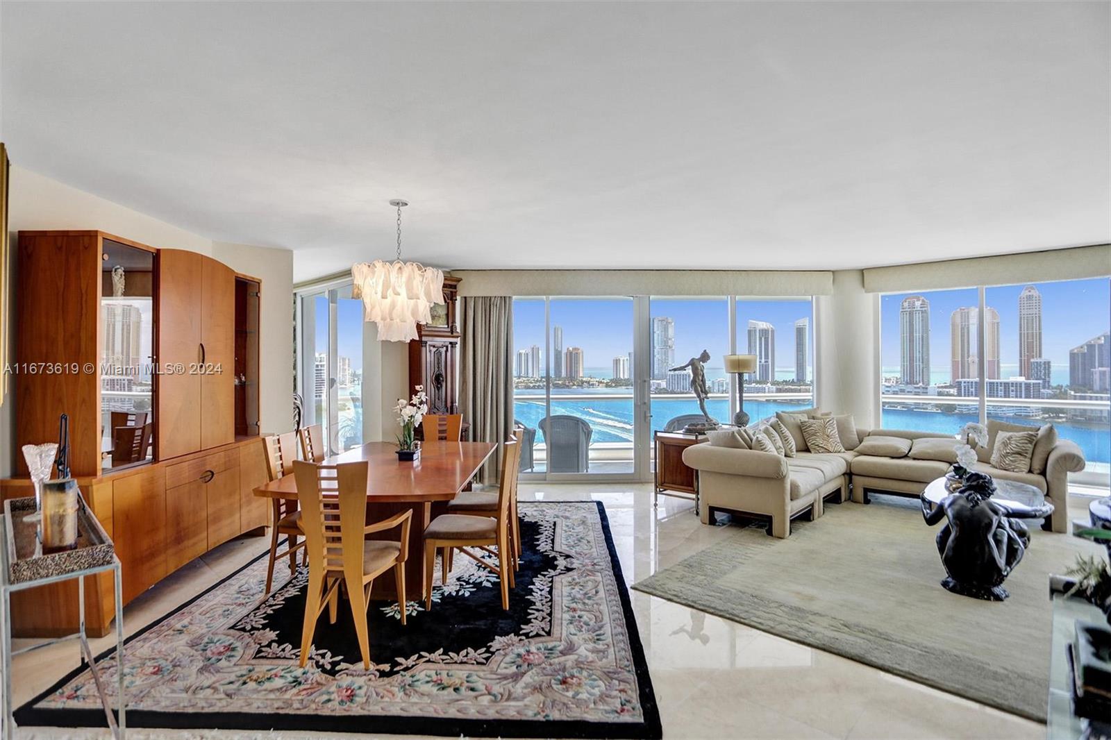 a living room with furniture kitchen view and large windows