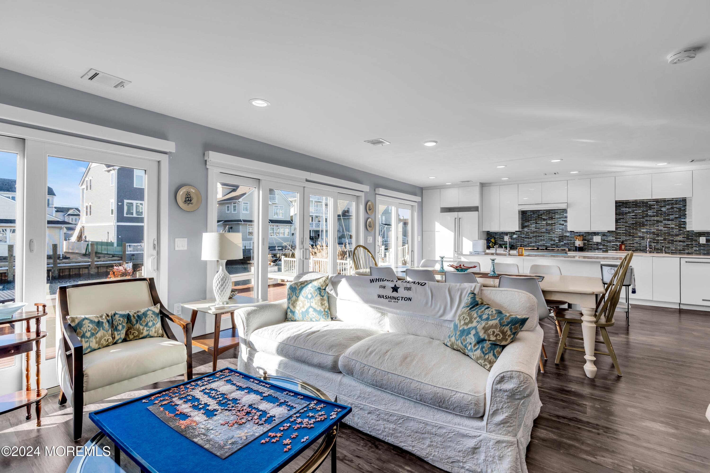 a living room with furniture wooden floor and a table