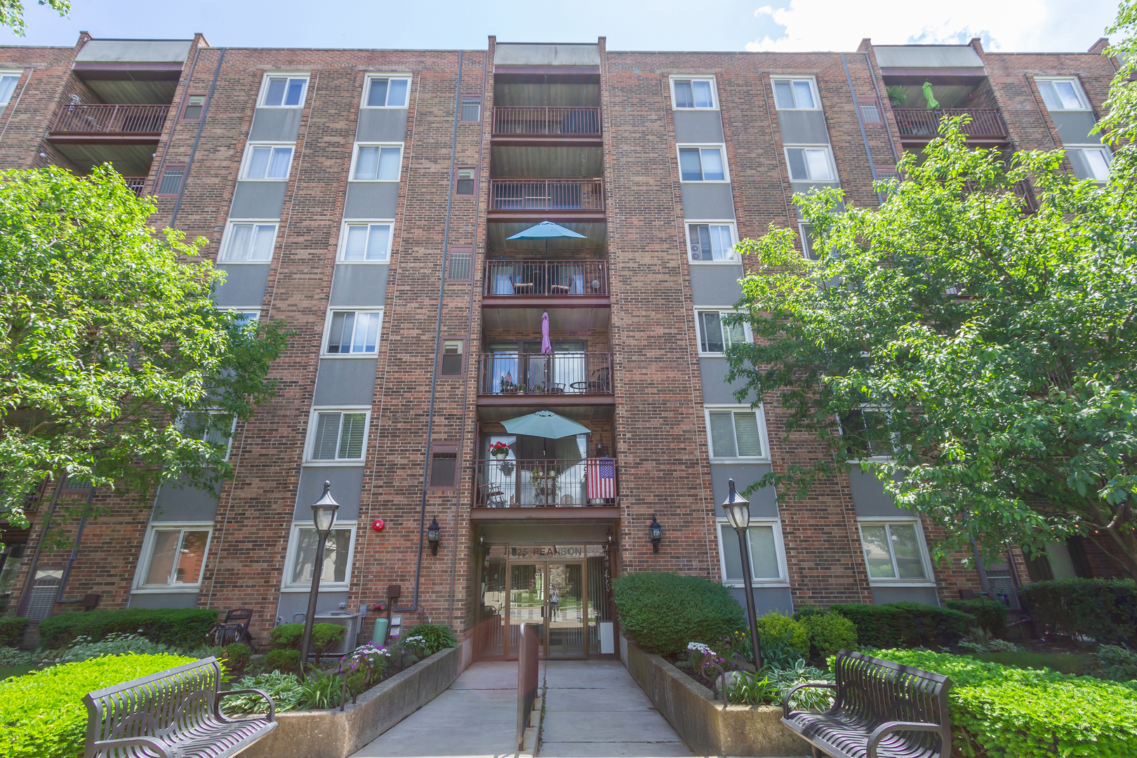 a front view of a multi story building with yard