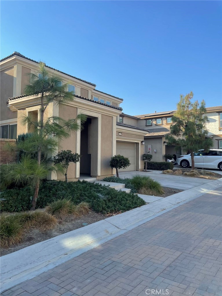 a front view of a house with a yard and a garage