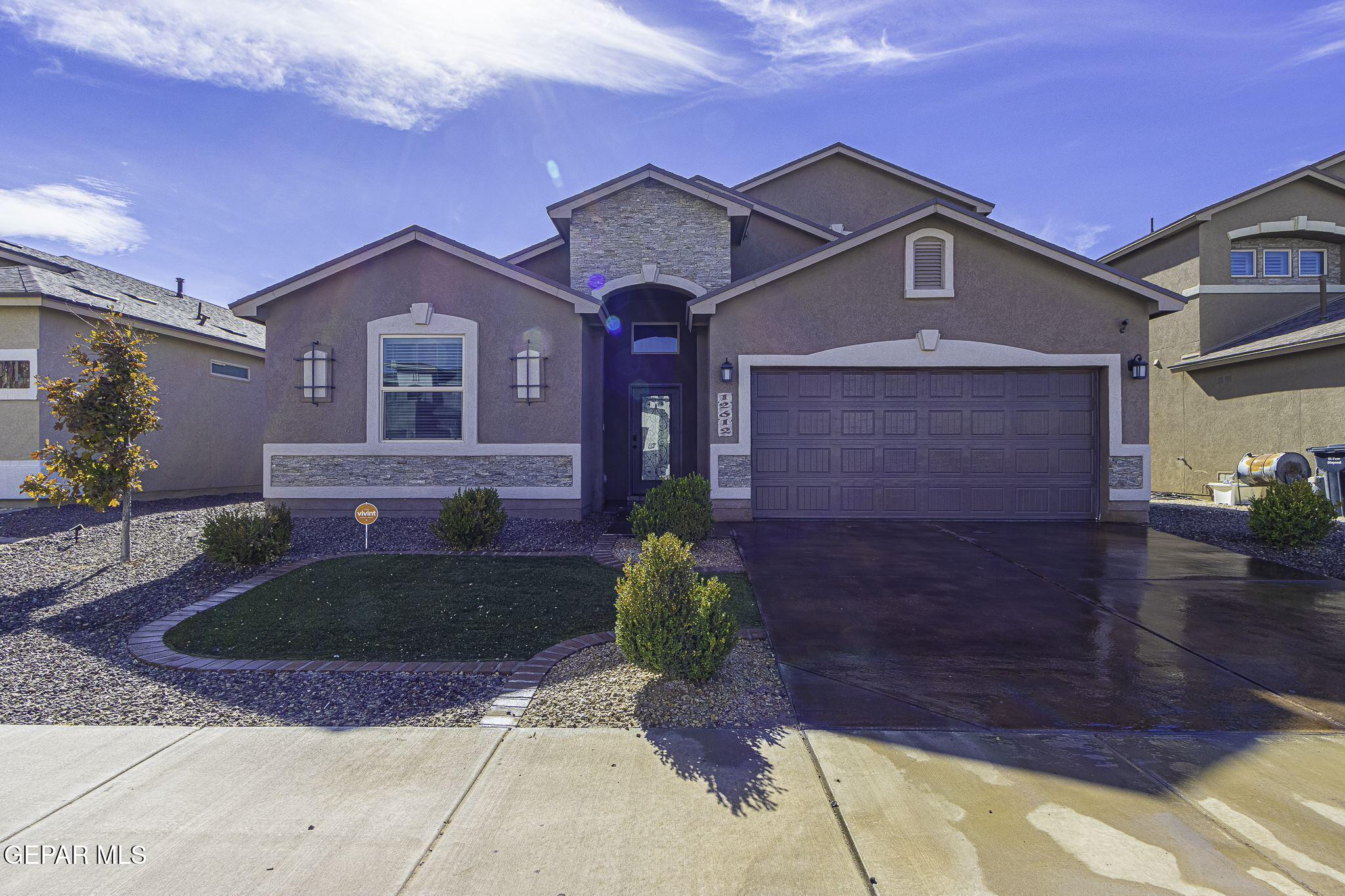 a front view of a house with garden