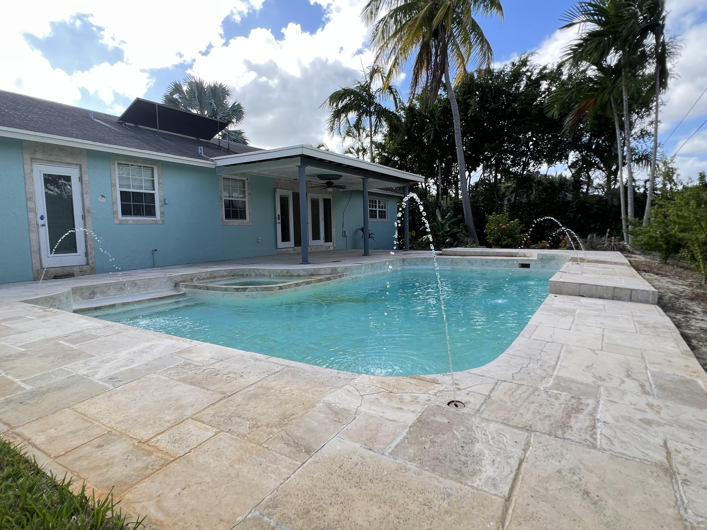 a view of a house with a backyard