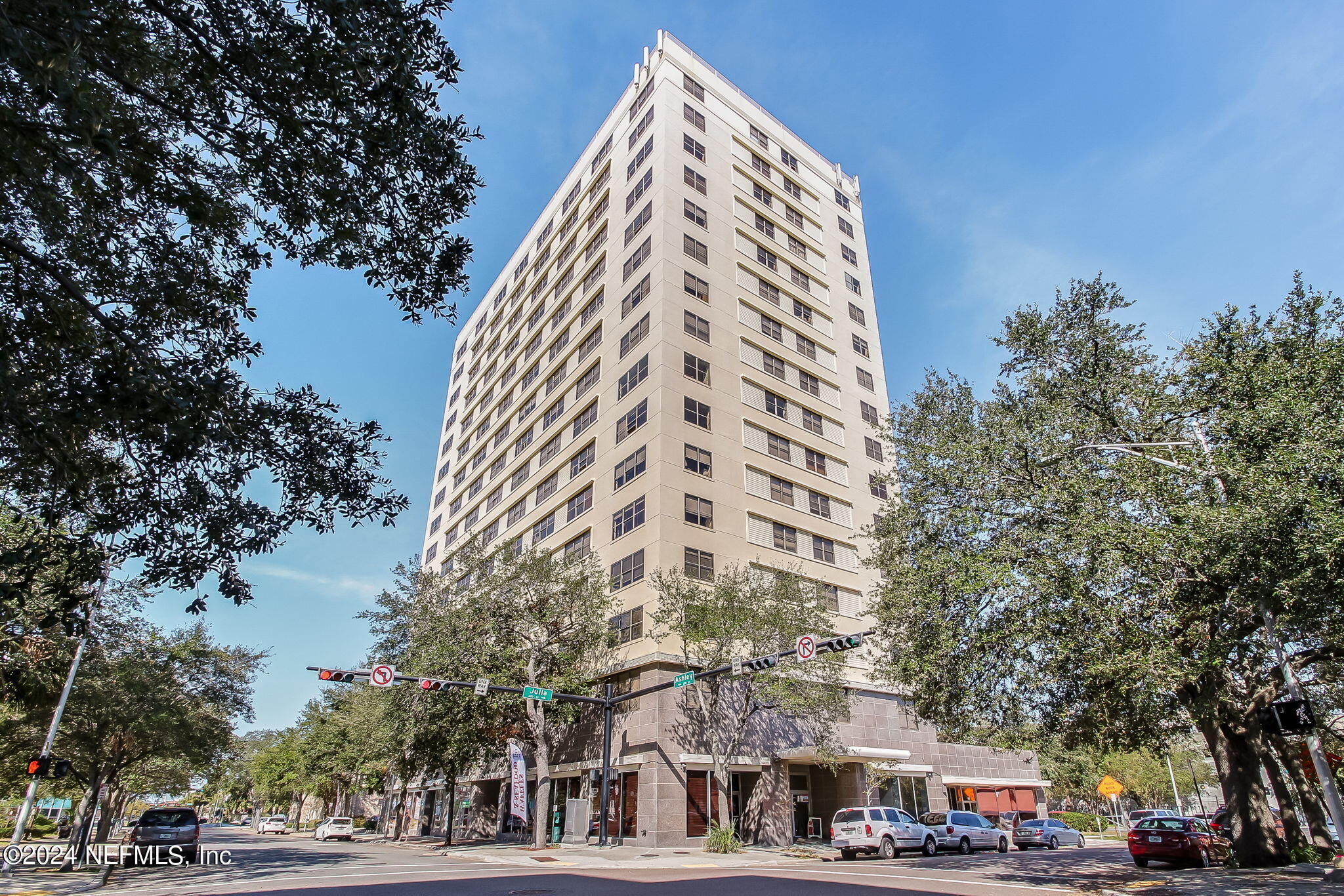 a view of a tall building next to a road