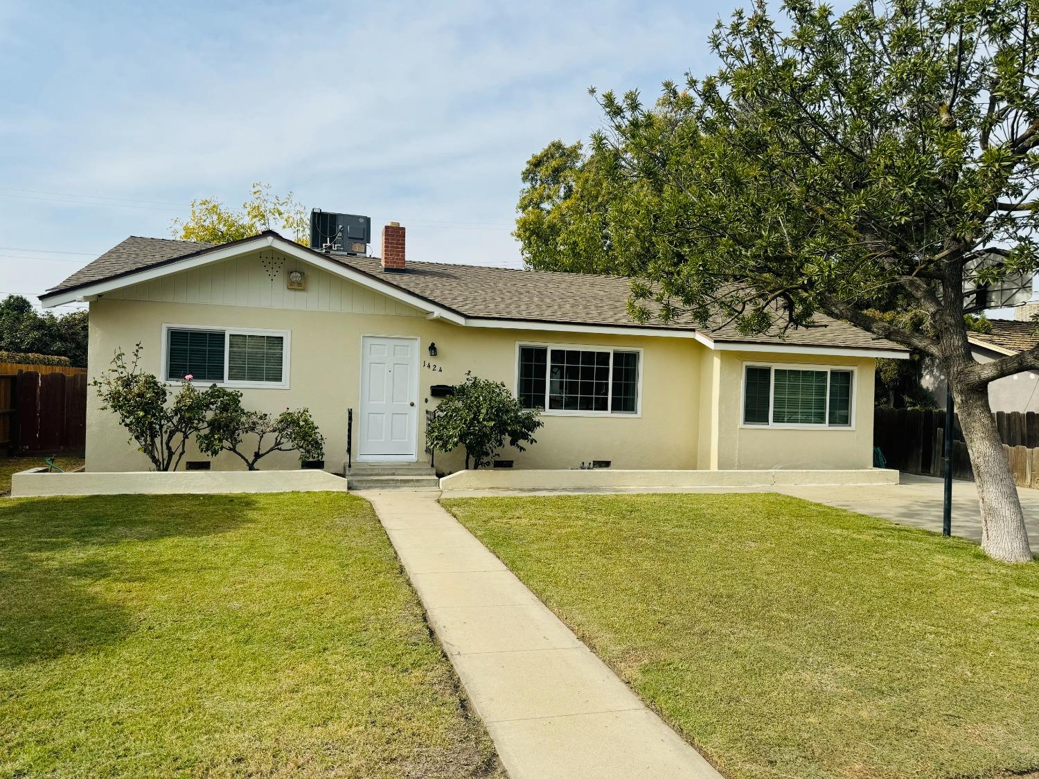 a front view of house with yard and trees