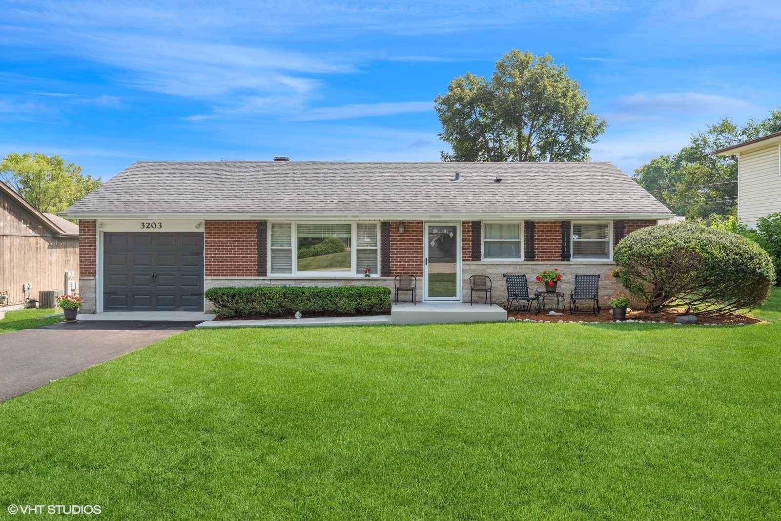 a front view of a house with a garden