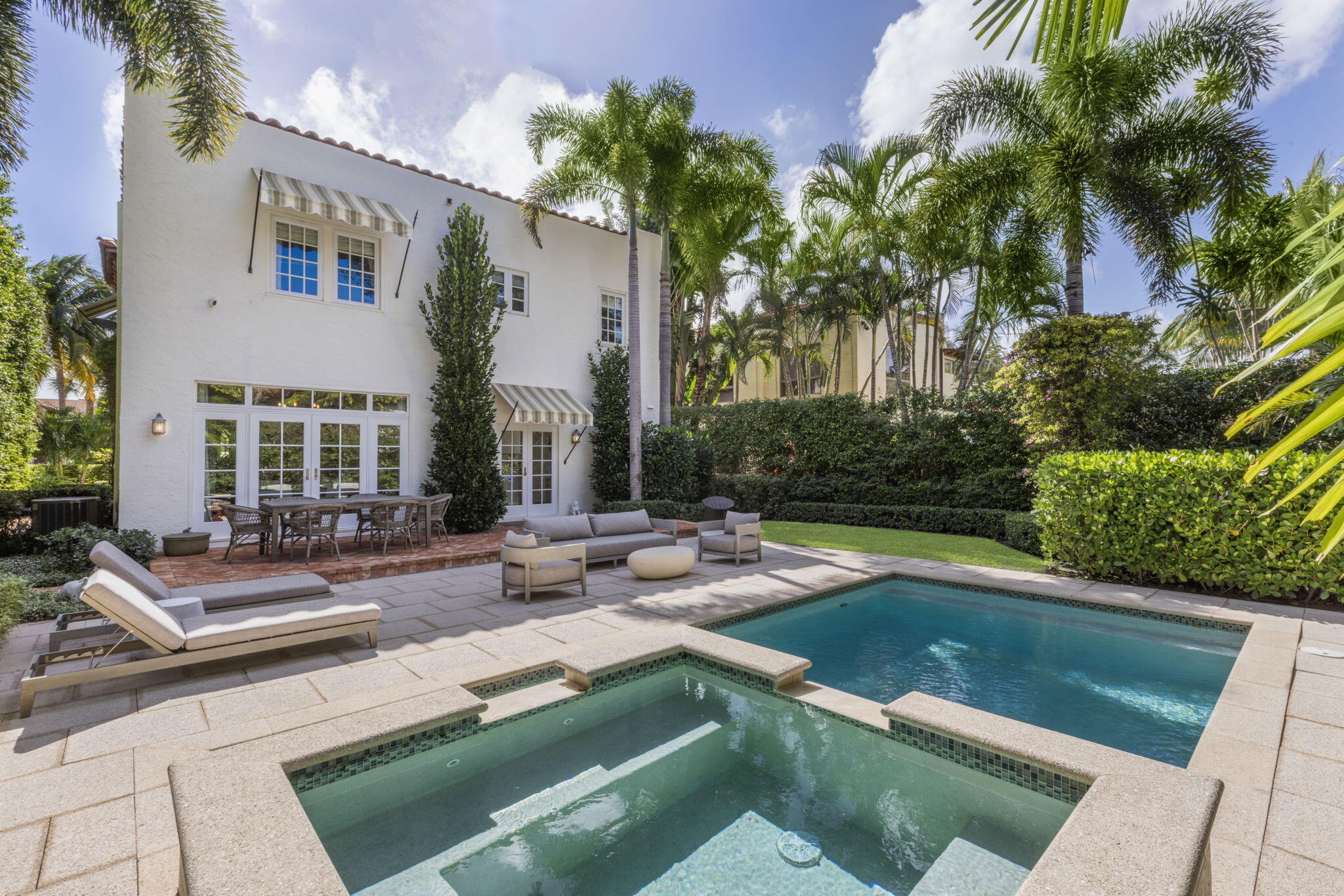 a view of a house with swimming pool and sitting area