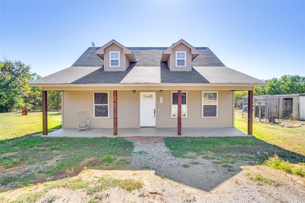 a front view of a house with a yard and porch