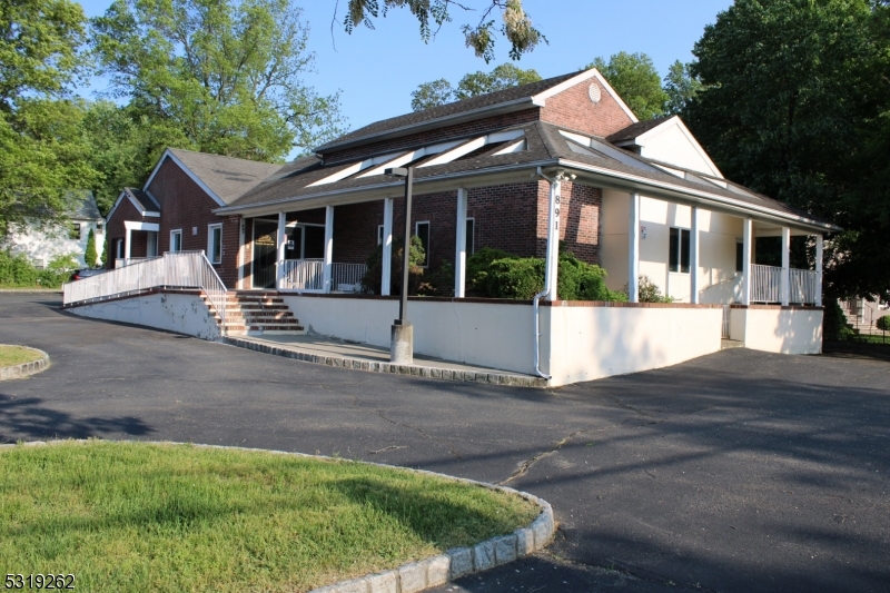 a view of a house with a yard and porch