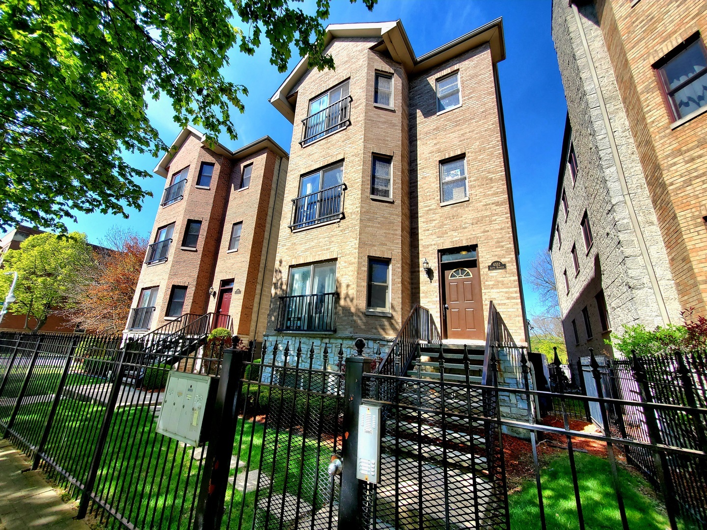 a front view of a building with glass windows and brick walls