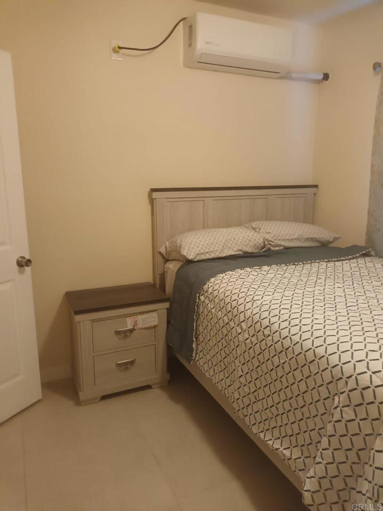 a bedroom with a bed and cabinet