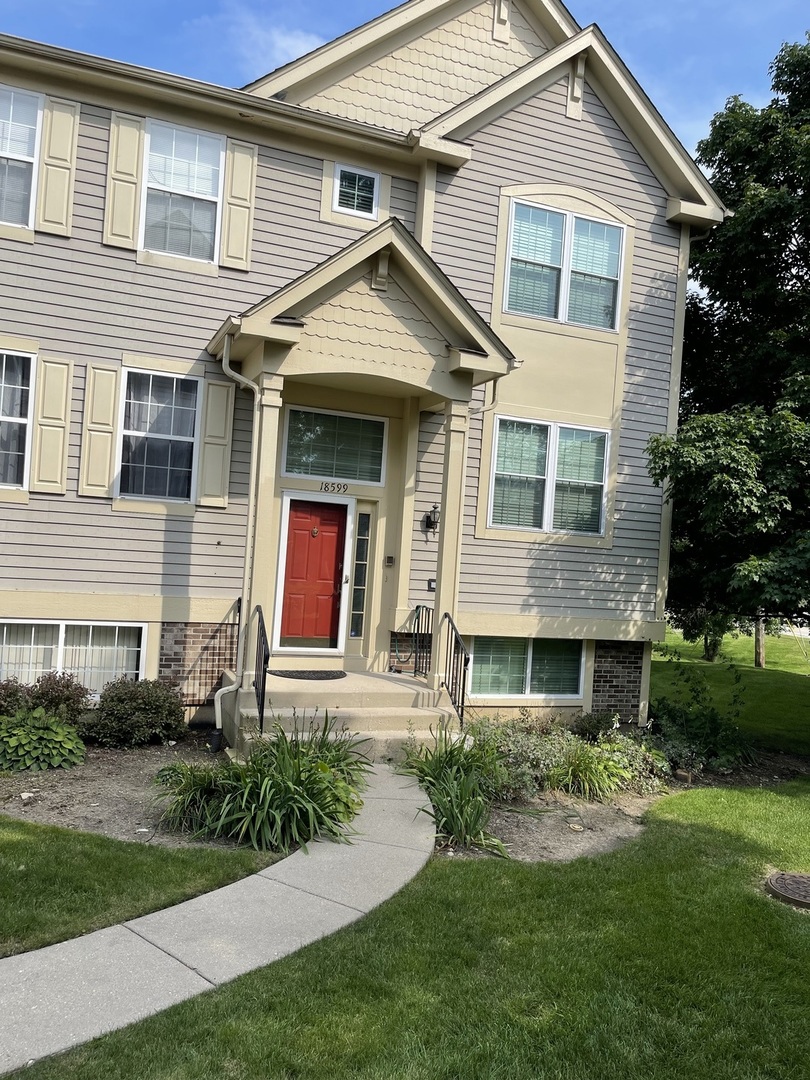 a front view of a house with garden