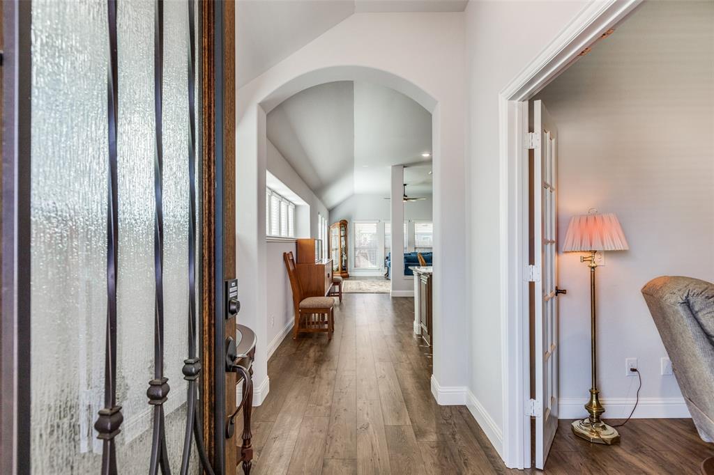 a view of a hallway with wooden floor and furniture