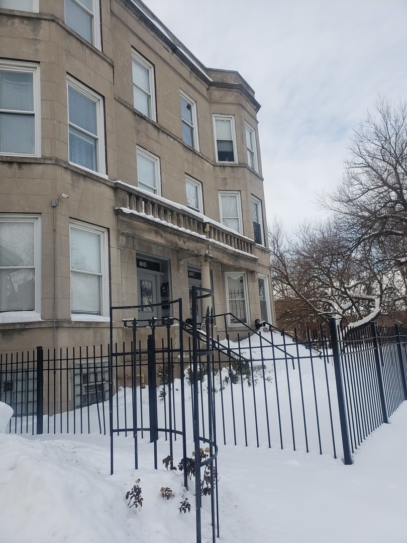 a view of a house with iron fence