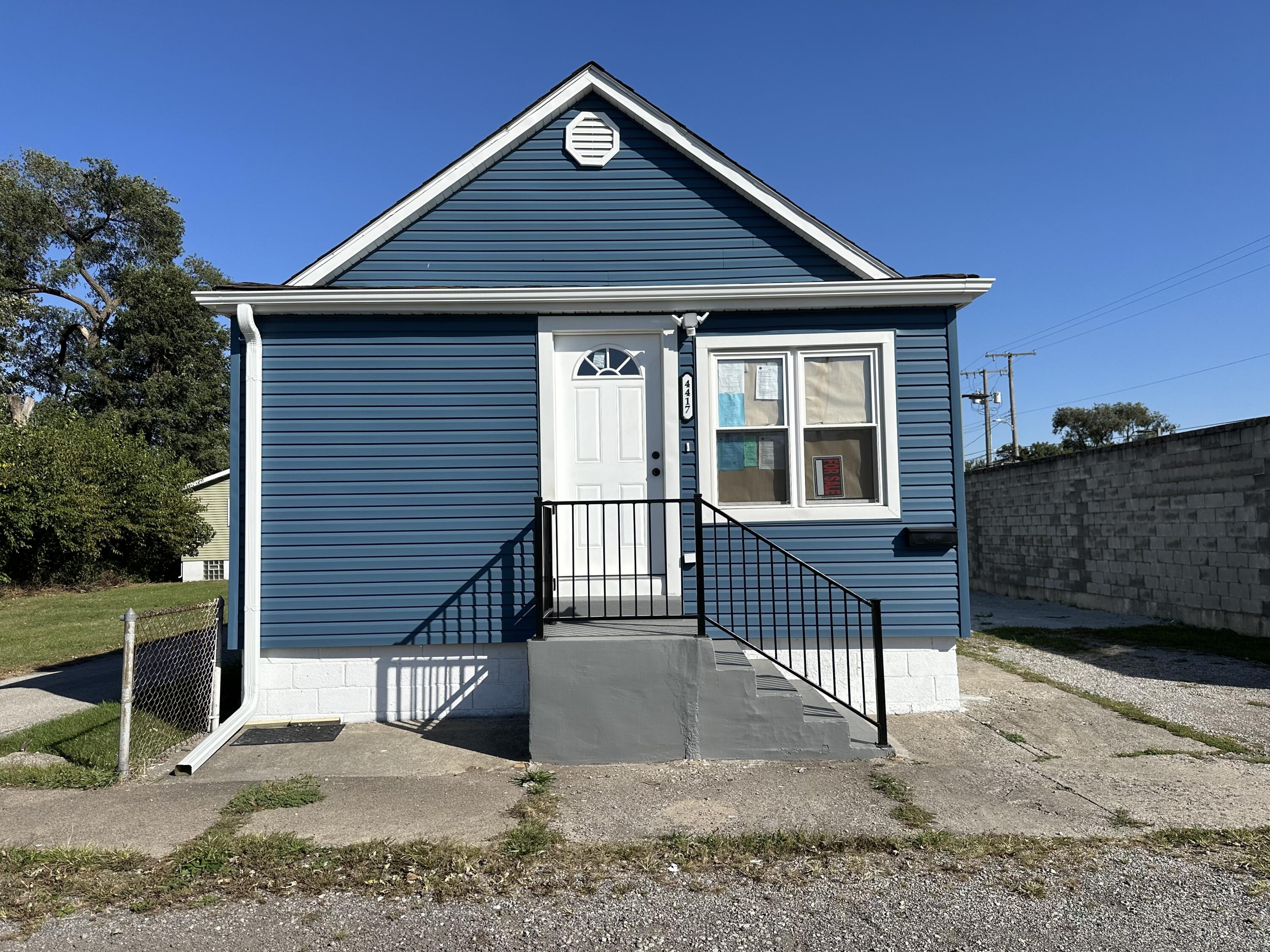 a front view of a house with a wooden fence