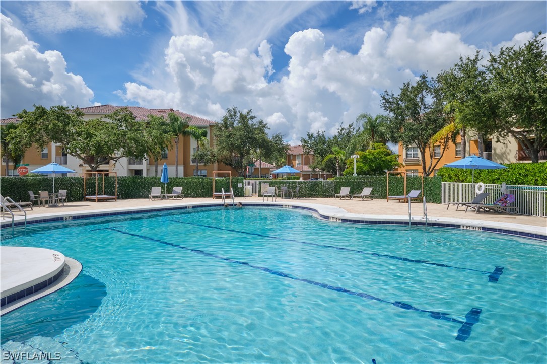 a view of yard with swimming pool and green space