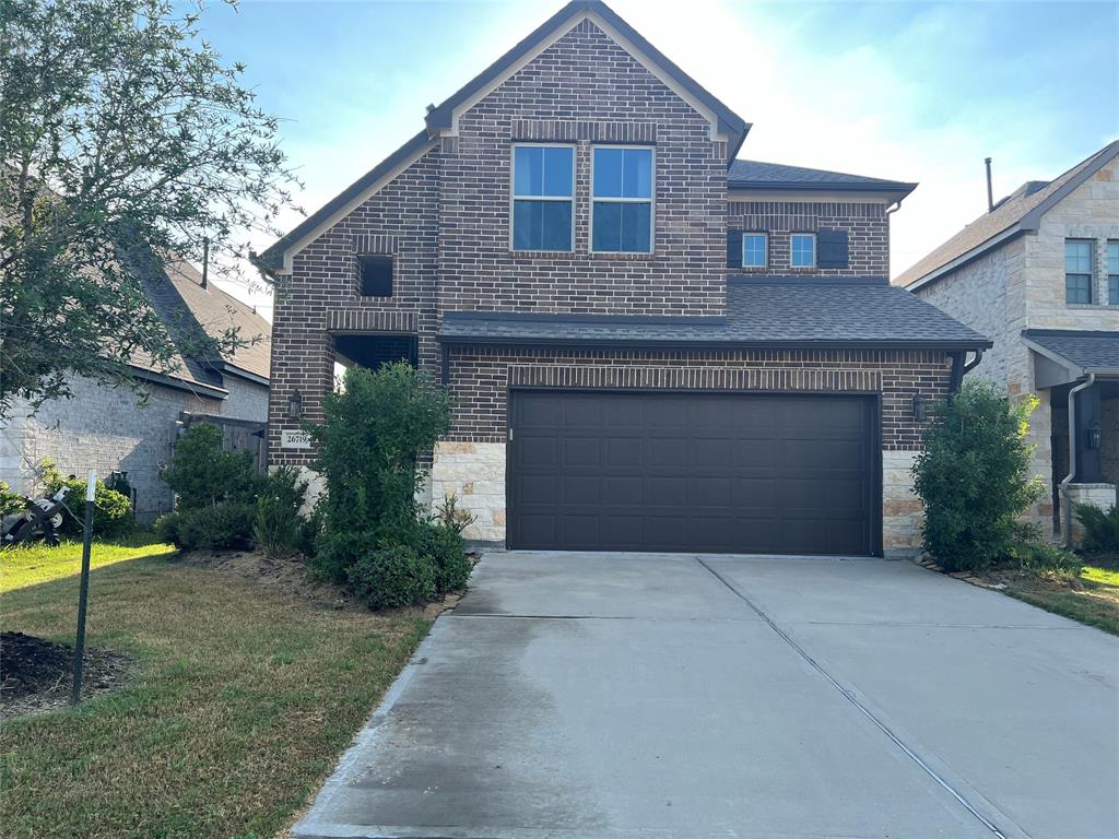 a front view of a house with a yard and garage