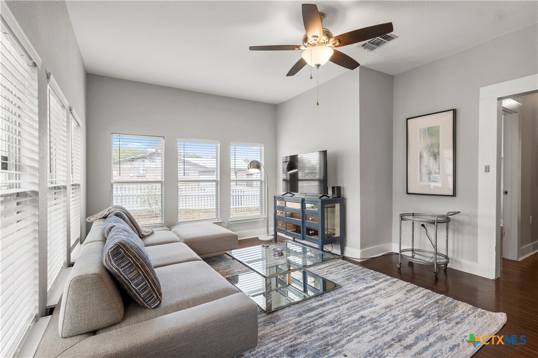 a living room with furniture and a large window