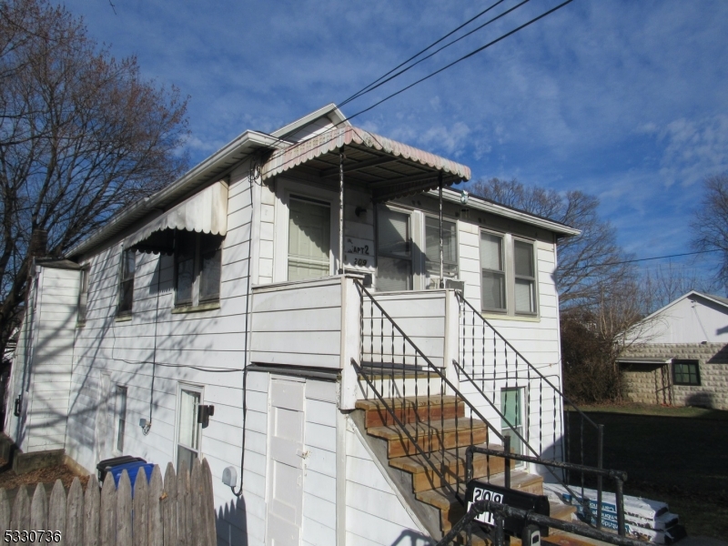 a view of wooden house with a large windows