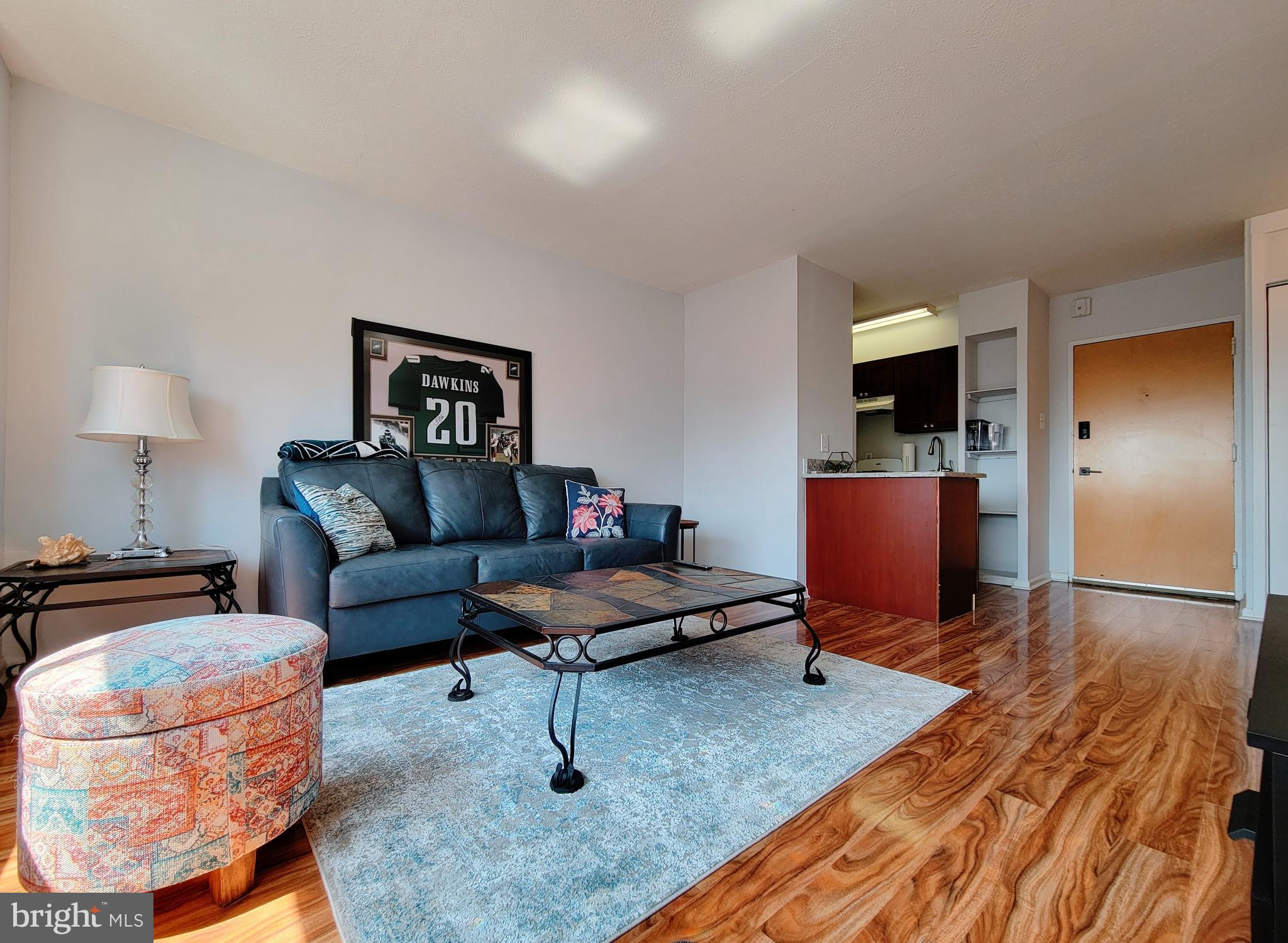 a living room with furniture and a wooden floor