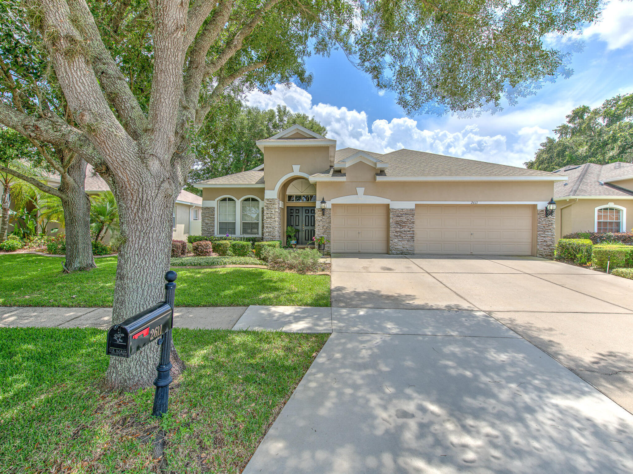 a front view of a house with a yard and garage