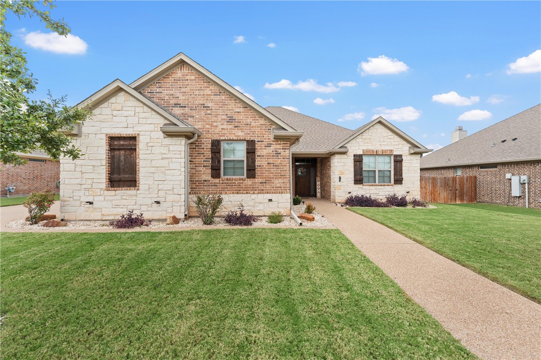 a front view of house with yard and green space