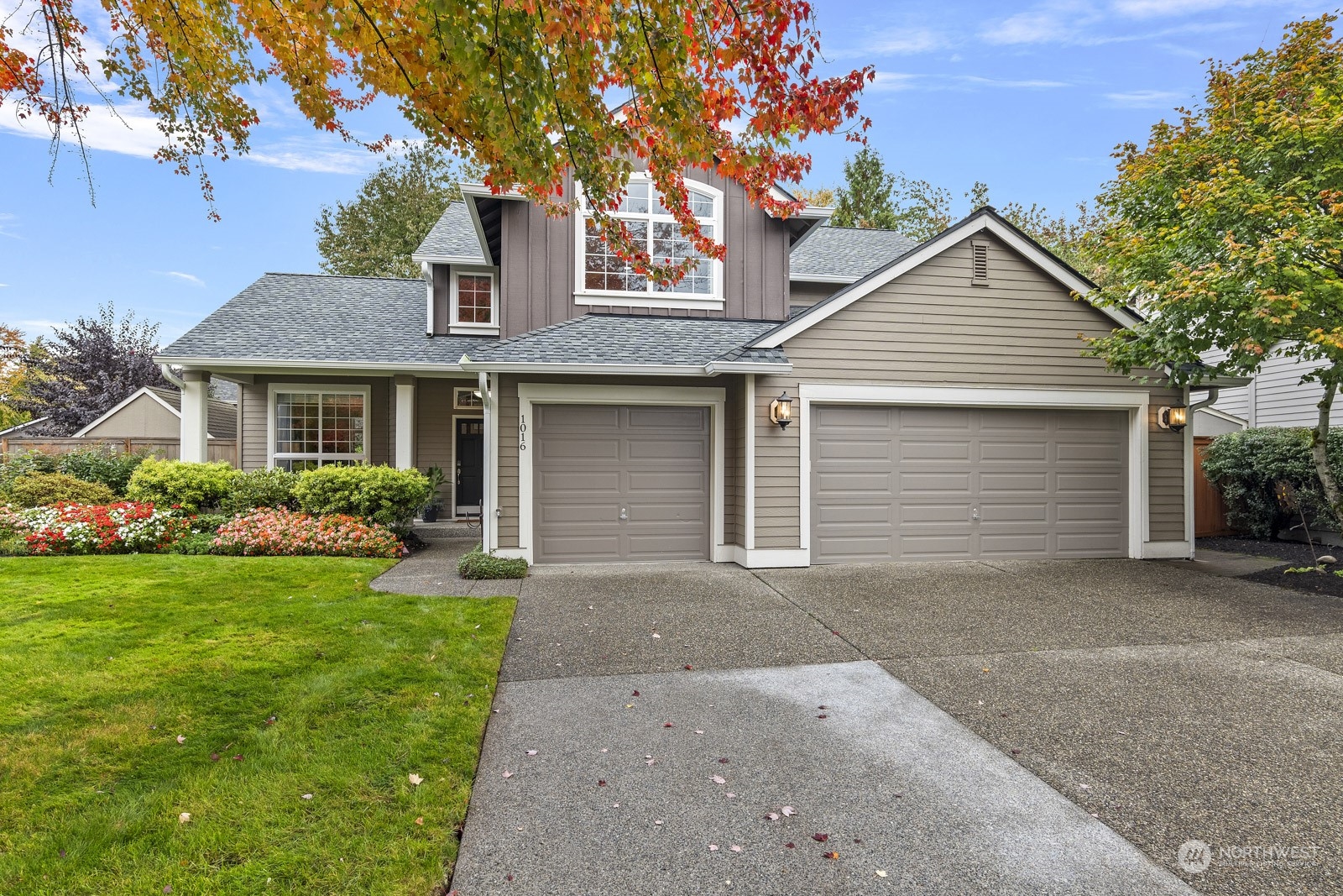 a front view of a house with a yard and garage