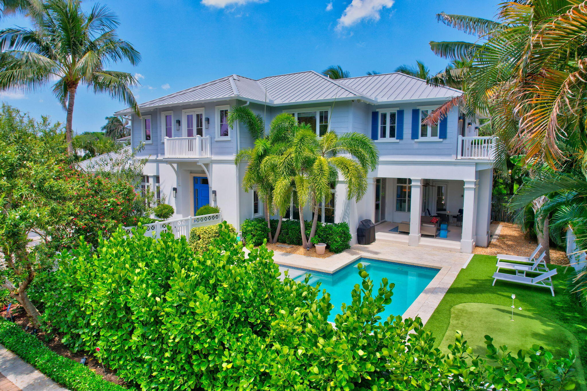 a front view of a house with a garden