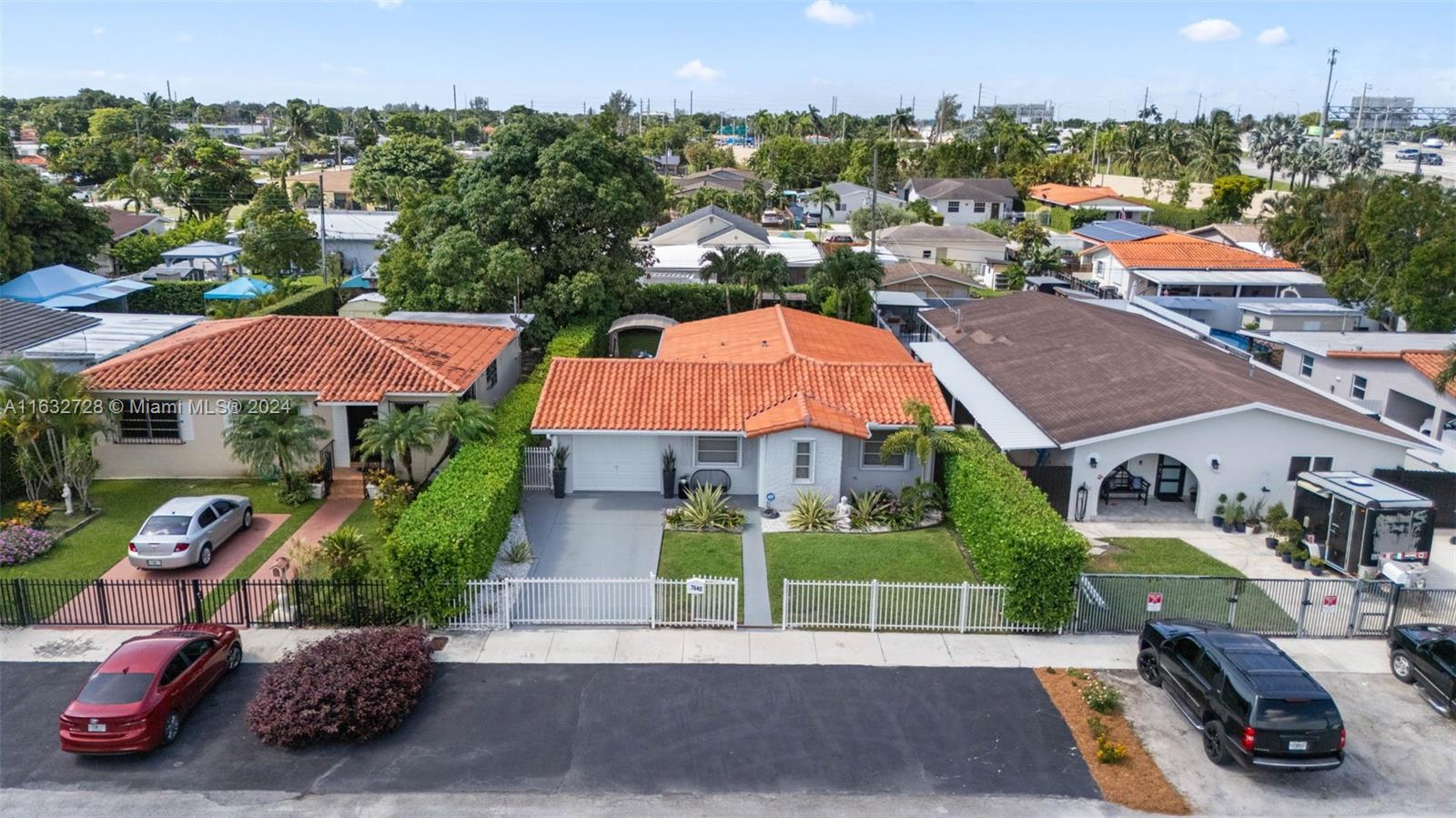 an aerial view of multiple houses with a yard