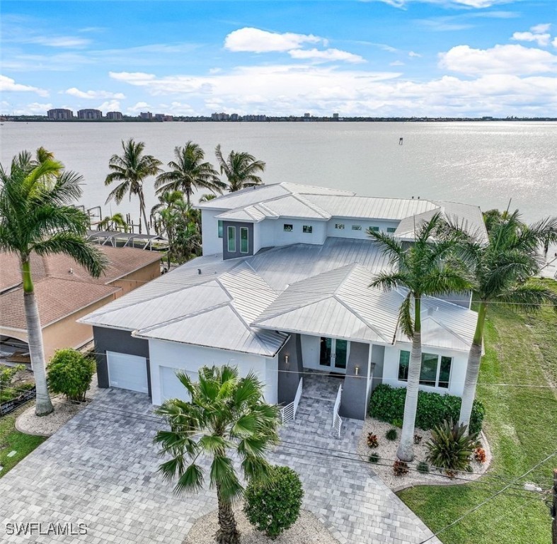 a aerial view of a house with a yard and lake view