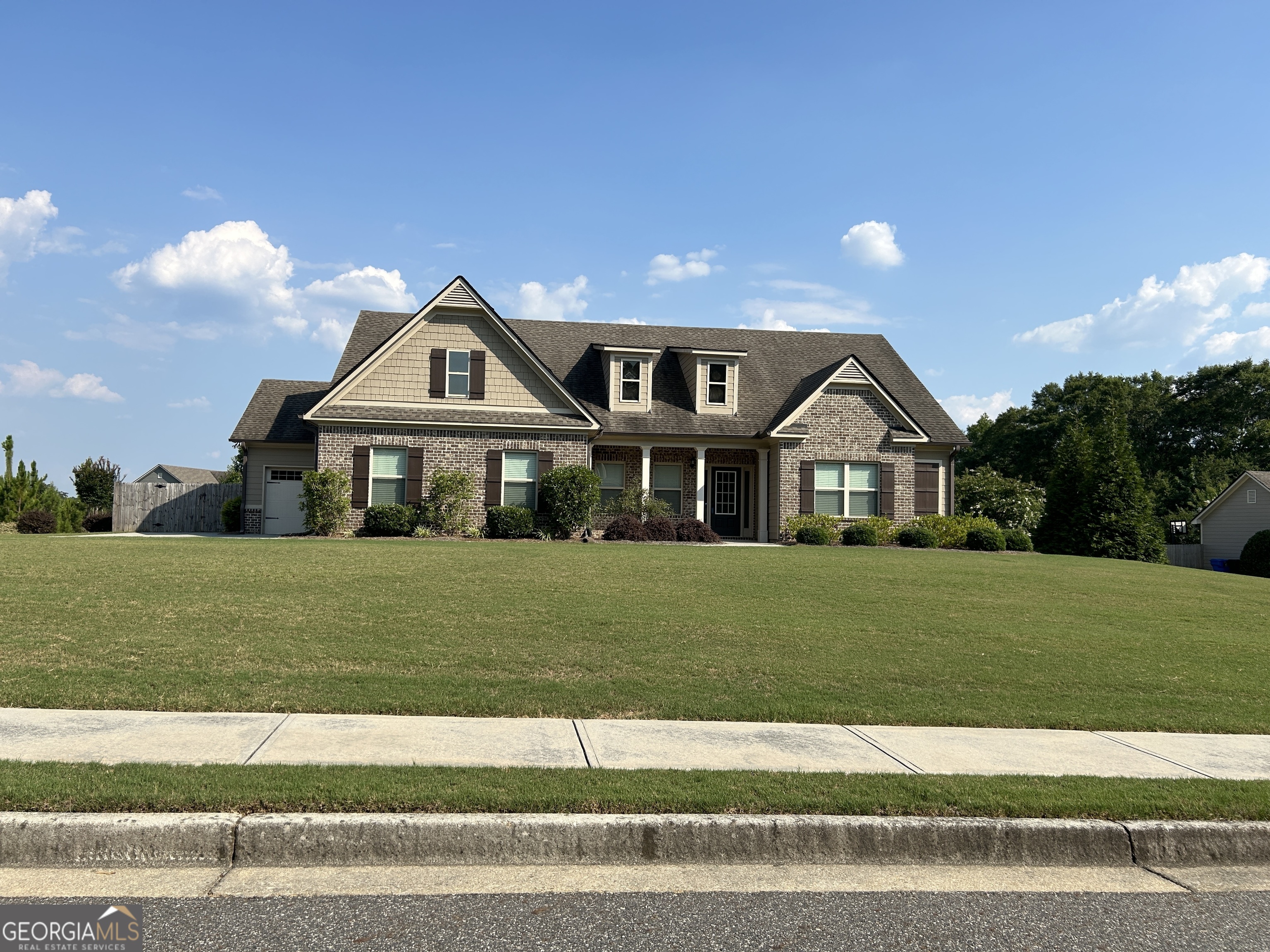 a front view of a house with a yard