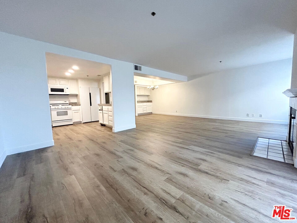 a view of a kitchen with wooden floor