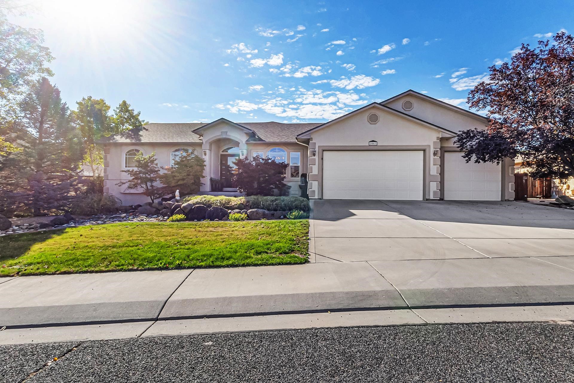 a front view of a house with a yard and garage