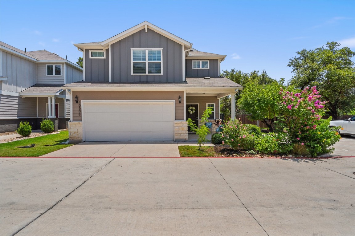 a front view of a house with a yard and a garage