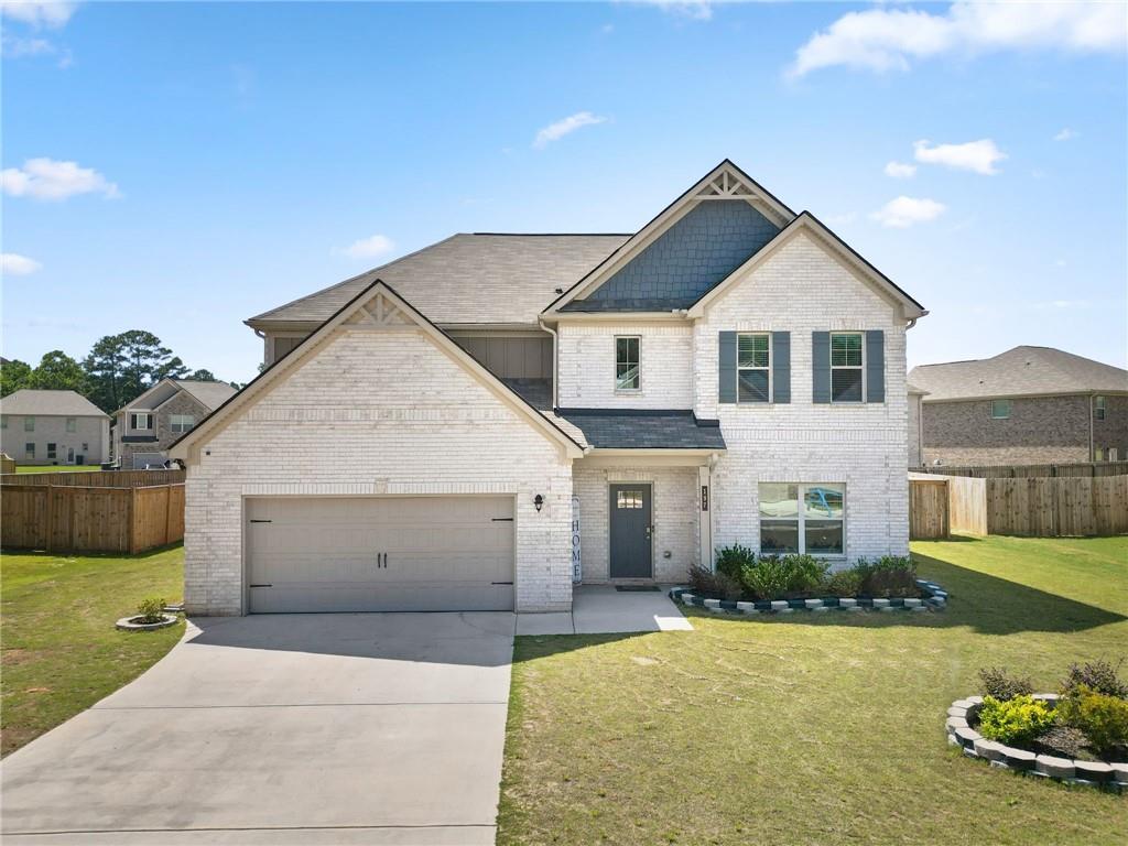 a front view of a house with a yard and garage