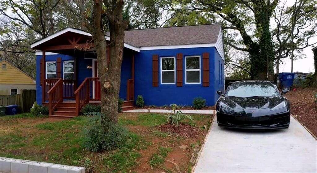 a house view with a sitting space and garden