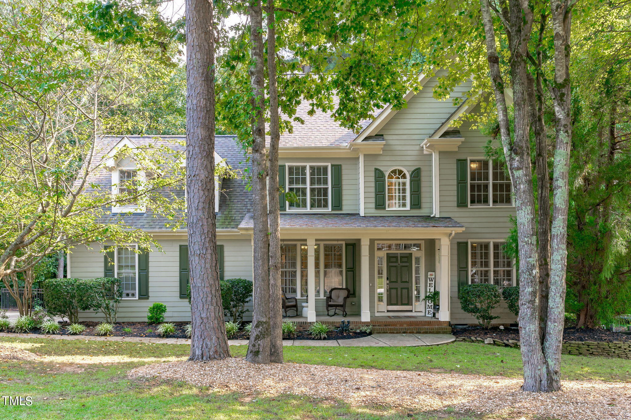 front view of a brick house with a yard