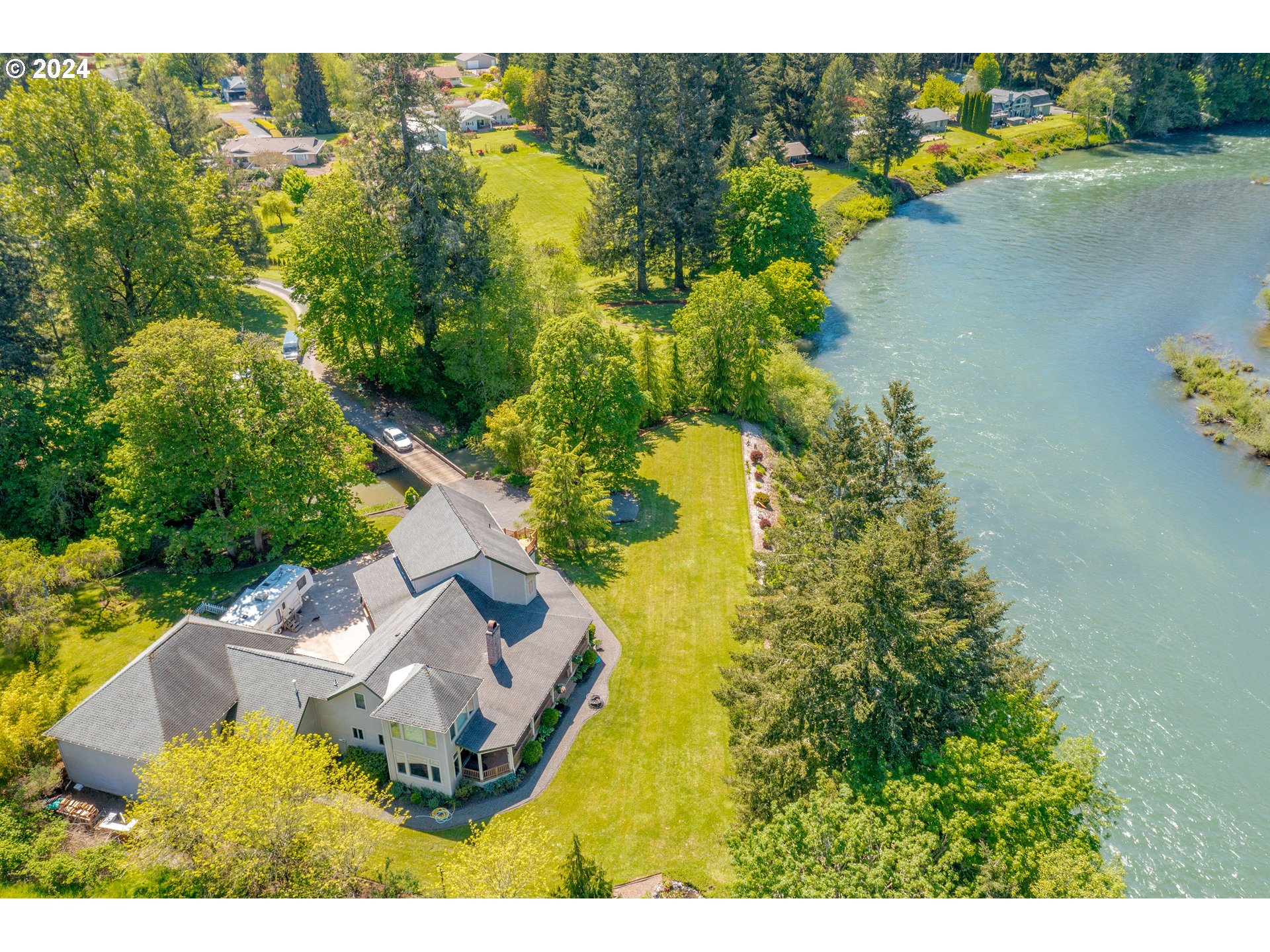 an aerial view of residential houses with outdoor space and swimming pool