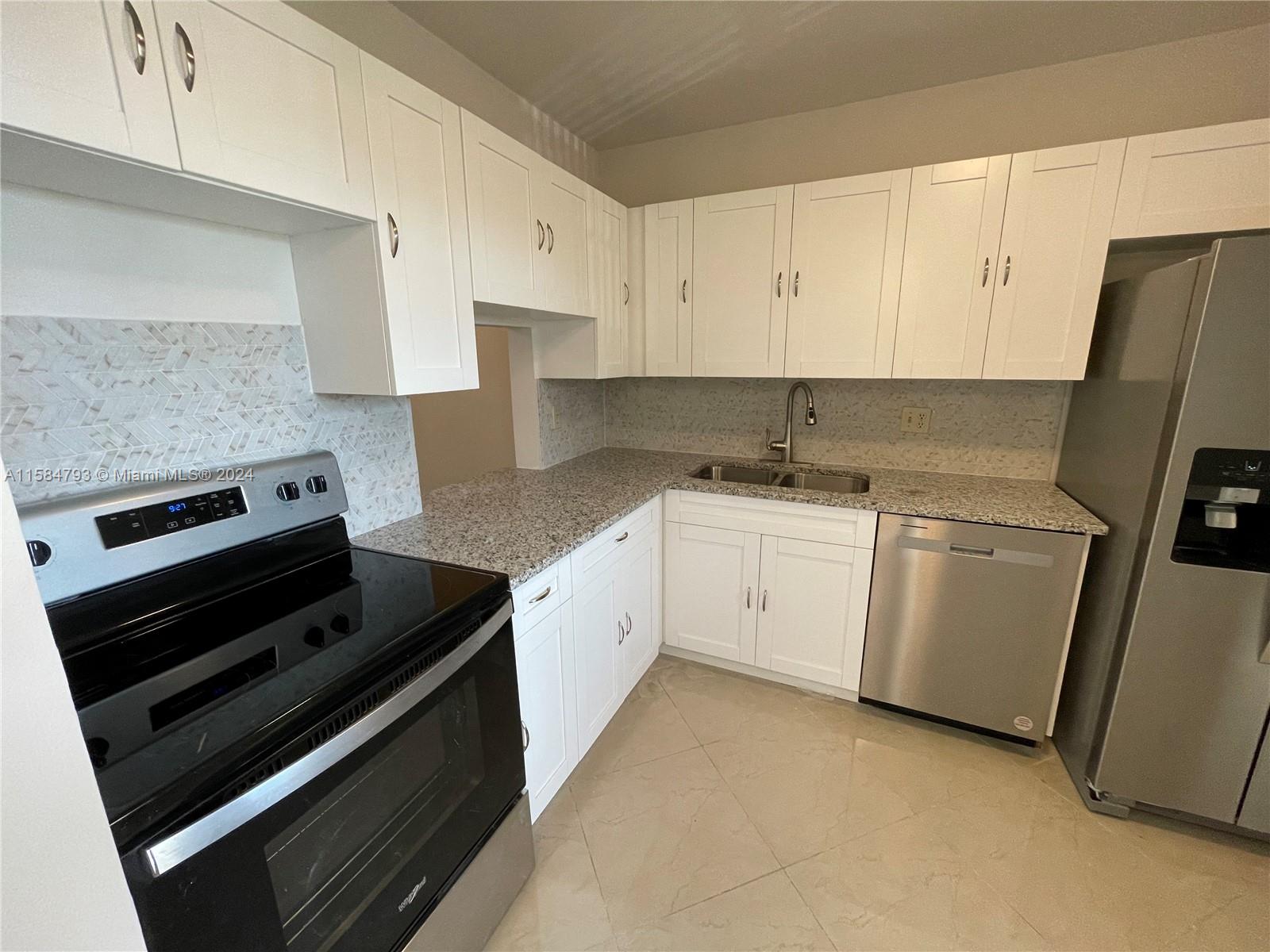 a kitchen with cabinets appliances and a sink