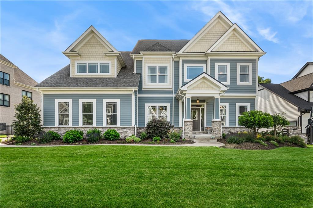 a front view of a house with porch and garden