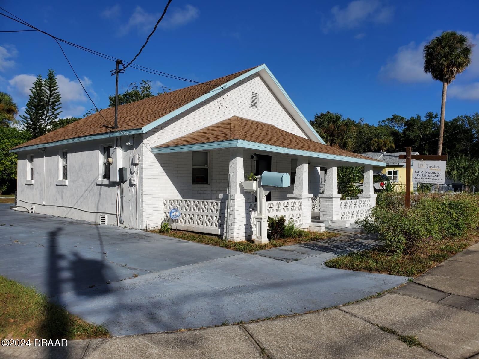 a front view of a house with a garden and garage