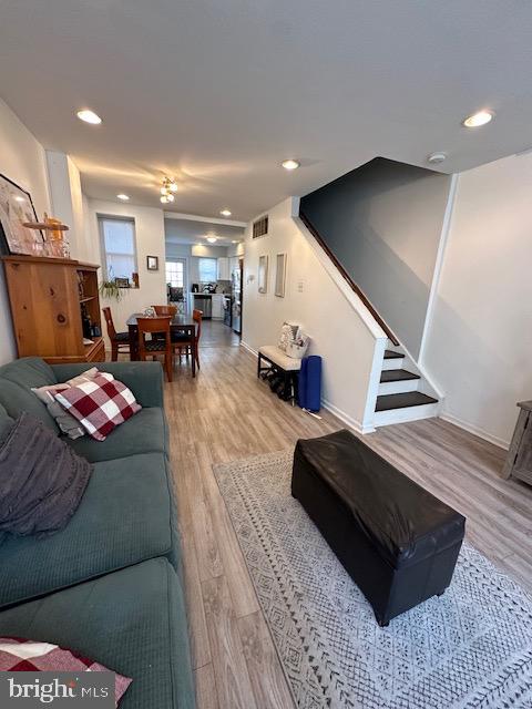 a living room with furniture and a ceiling fan