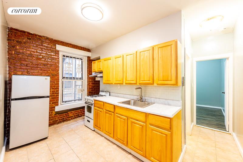 a kitchen with a refrigerator and a sink