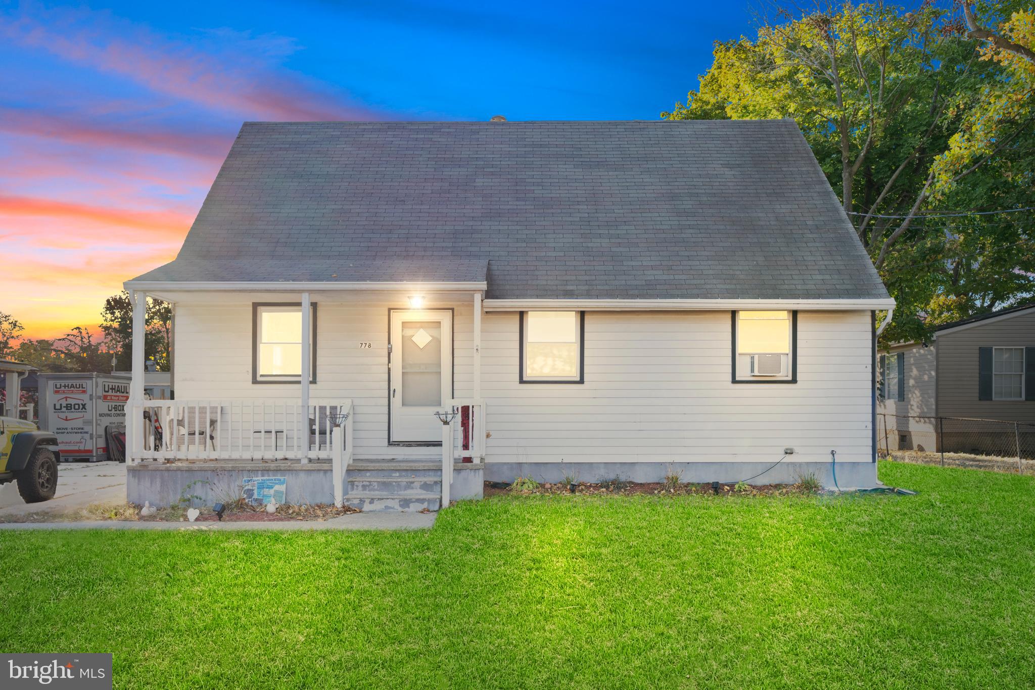 a front view of house with yard and outdoor seating