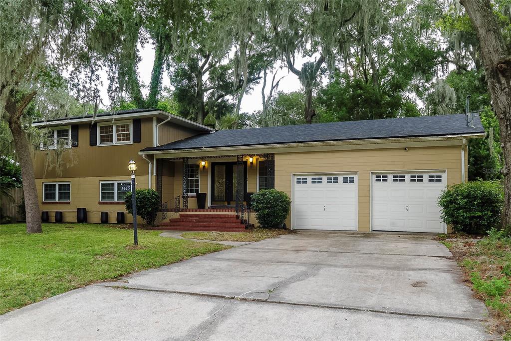 a front view of house with yard and green space