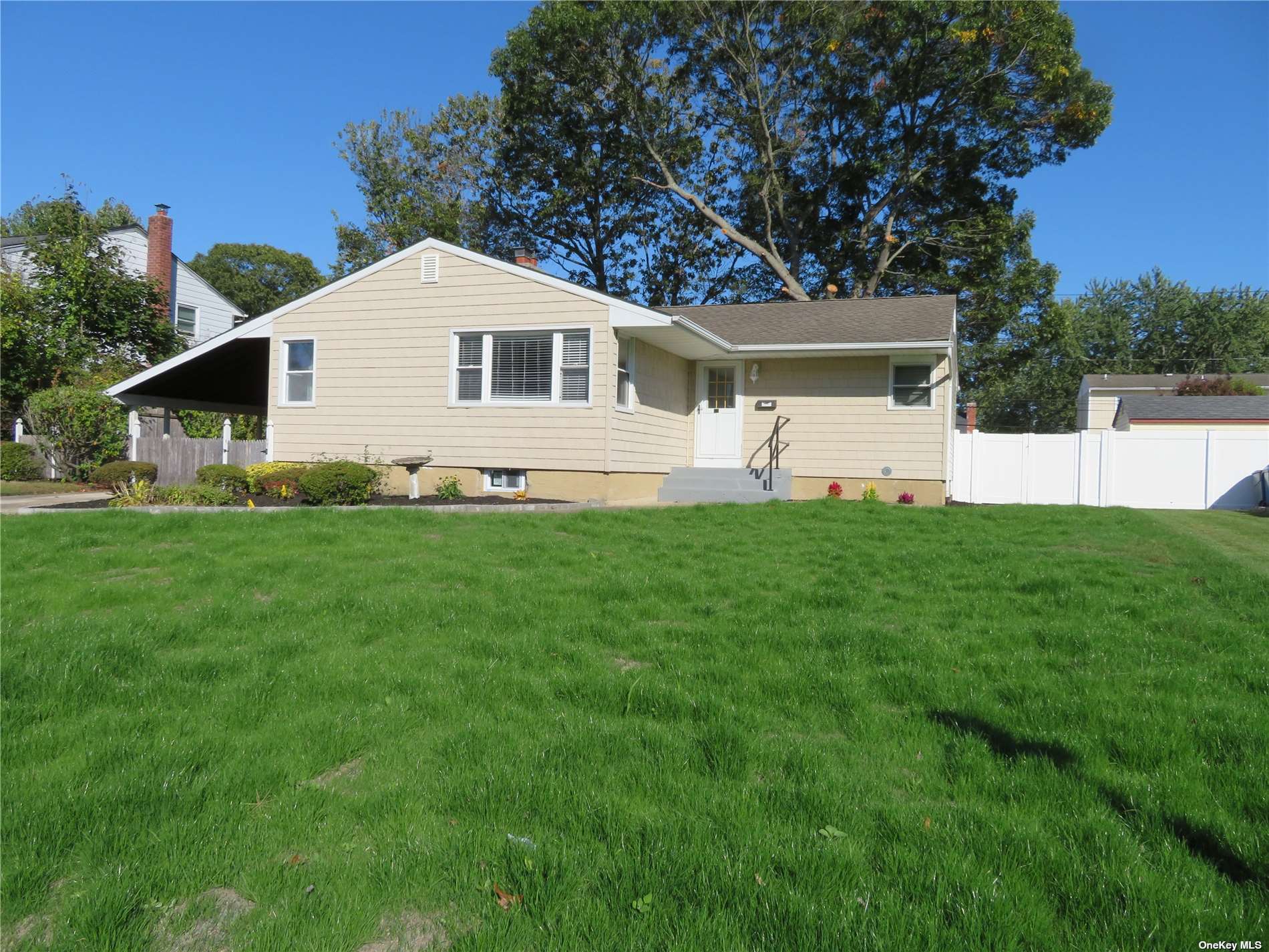 a front view of house with yard and trees