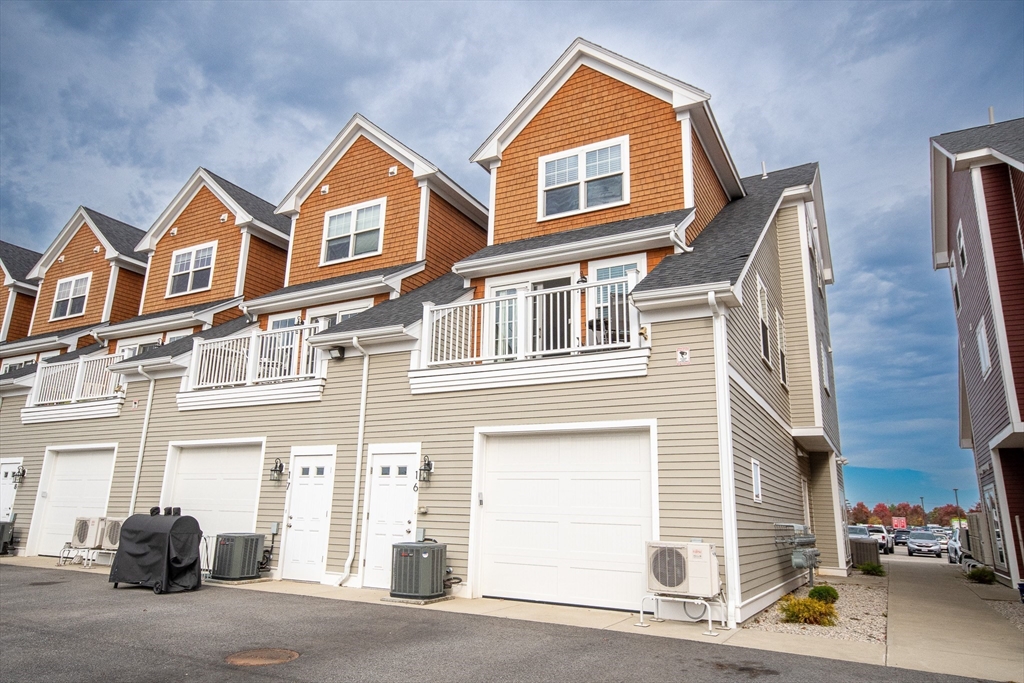 a front view of a residential houses with parking