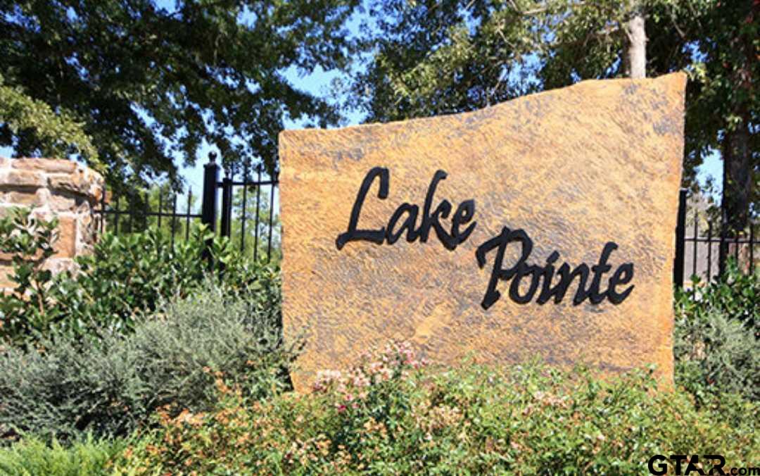 a view of a sign under a tree