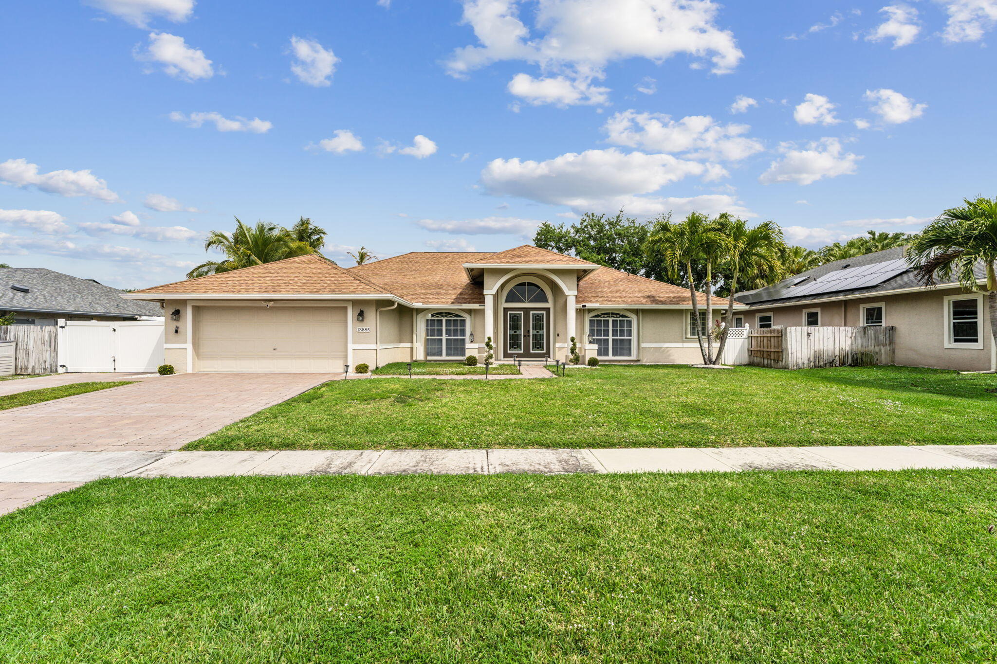 a front view of house with yard and green space