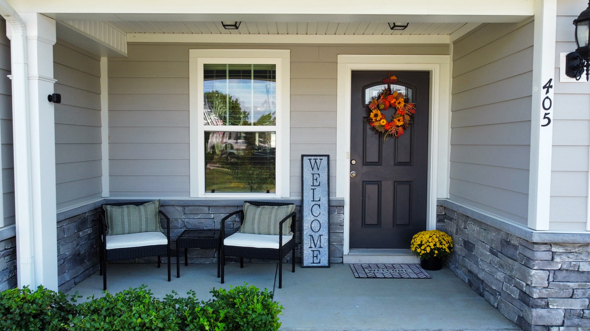 a front view of a house with outdoor seating